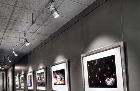 Contemporary Art Gallery Of Black & Grey Panels With Multiple Spotlights.
