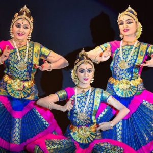 An image of 3 Bharatanatyam dancers in 3 different poses in-line to each other