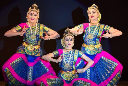 An image of 3 Bharatanatyam dancers in 3 different poses in-line to each other