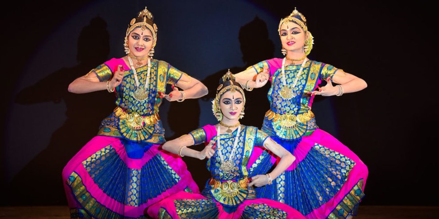 An image of 3 Bharatanatyam dancers in 3 different poses in-line to each other